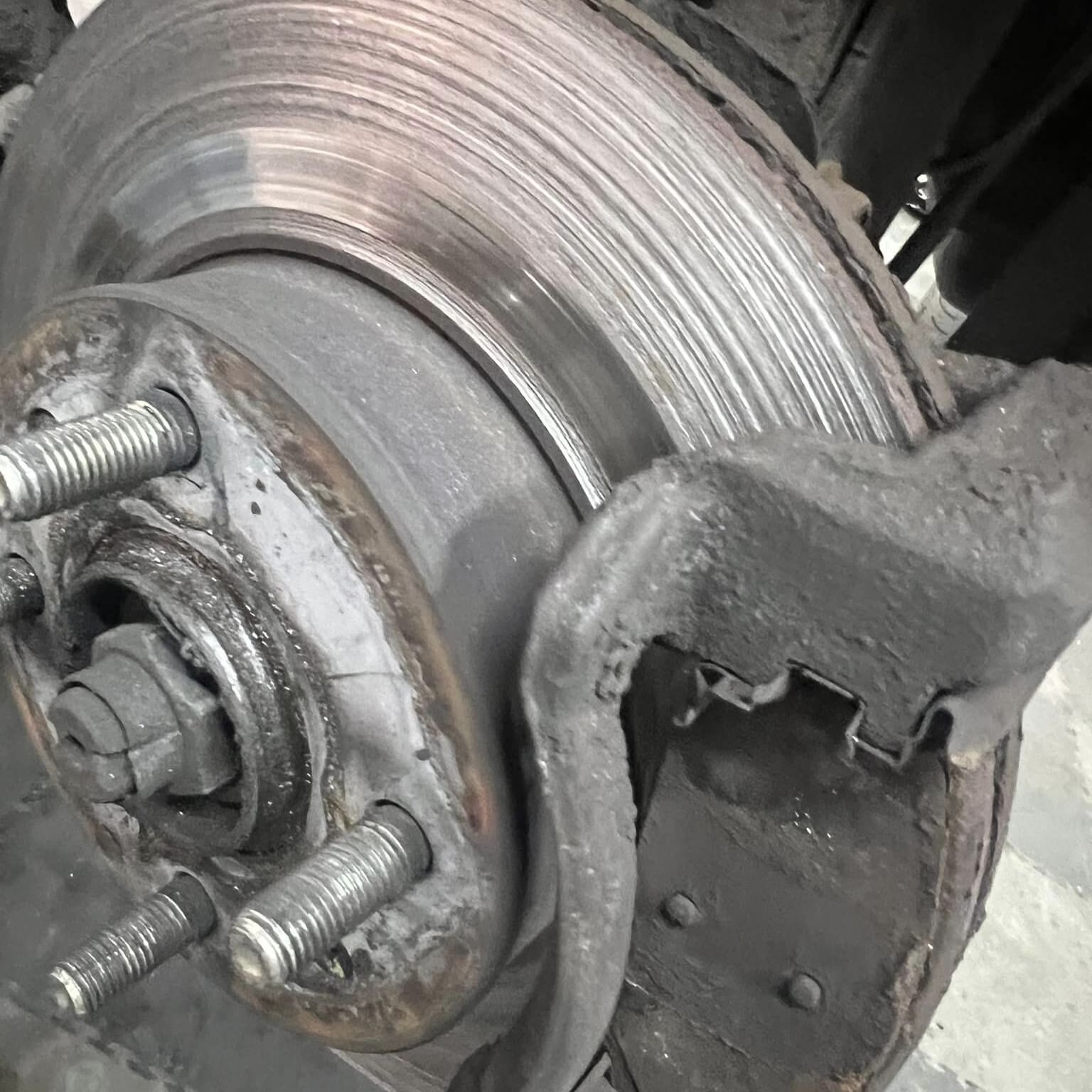 A brake disc being changed with the wheel off